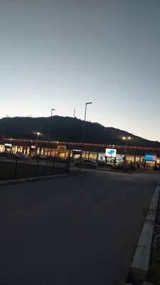 an empty street in front of a gas station at Apartman Zapadni Kej M&M in Pirot