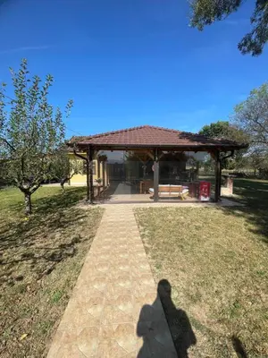 a shadow of a person standing in front of a pavilion at Vila Meadow in Gredetin