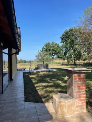 a patio with a picnic table in a park at Vila Meadow in Gredetin