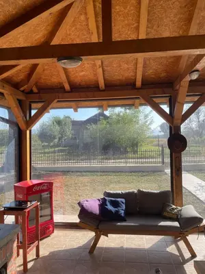a living room with a couch and a large window at Vila Meadow in Gredetin