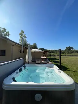 a jacuzzi tub on the back of a house at Vila Meadow in Gredetin
