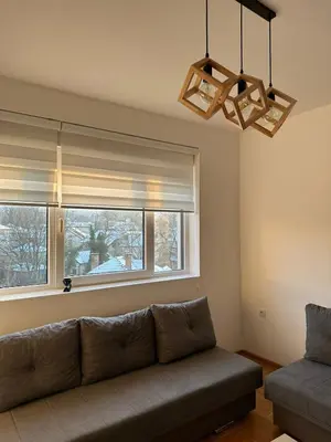 a living room with a couch and a window at Afrodita apartman in Vrnjci