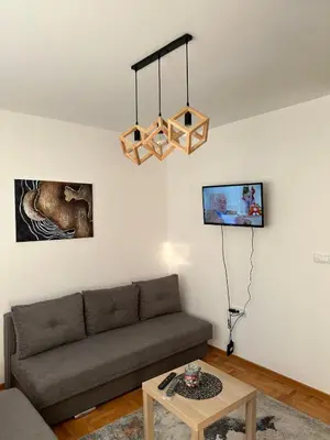 a living room with a couch and a table at Afrodita apartman in Vrnjci