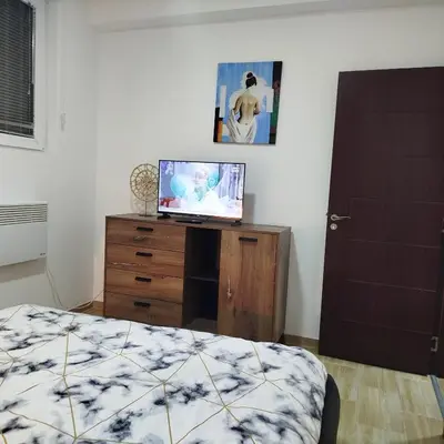 a bedroom with a bed and a tv on a dresser at Cera luxe apartment in Soko Banja