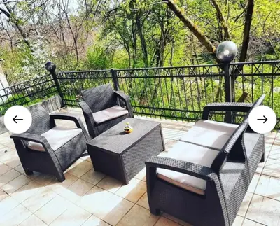 a patio with three chairs and a table at Cera luxe apartment in Soko Banja