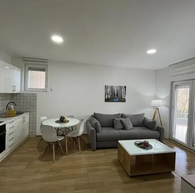 a living room with a couch and a table at Cera luxe apartment in Soko Banja