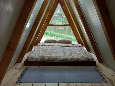 a bed in a room with a large window at Vip Villa Jagodina - Jakuzzi is free - Private parking is free - Beautiful view of nature in Jagodina
