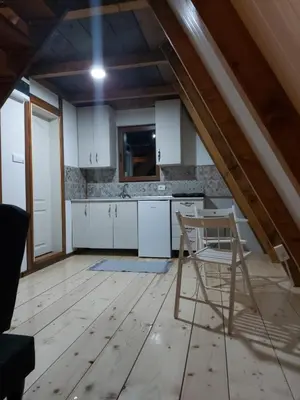 a kitchen with white cabinets and a chair in it at Vip Villa Jagodina - Jakuzzi is free - Private parking is free - Beautiful view of nature in Jagodina