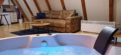 a bath tub in a living room with a couch at Vip Villa Jagodina - Jakuzzi is free - Private parking is free - Beautiful view of nature in Jagodina