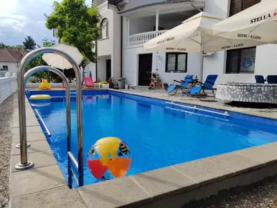 a swimming pool with a ball in the middle of it at Vila Jovana in Rogljevo