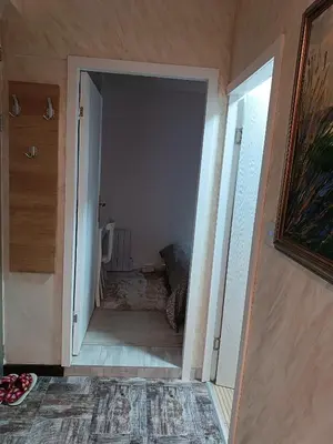 a hallway with an open door to a room at M Central Park in Niš