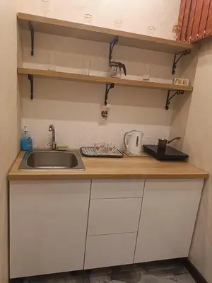 a kitchen with a sink and a counter top at M Central Park in Niš
