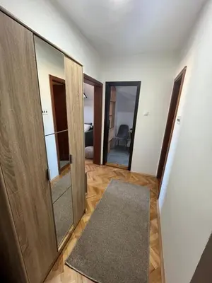 a hallway with two doors and a rug in a room at Stanoteka in Vrnjačka Banja