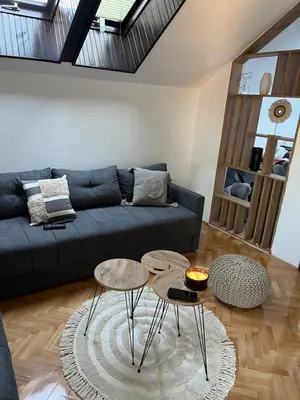 a living room with a couch and two tables at Stanoteka in Vrnjačka Banja