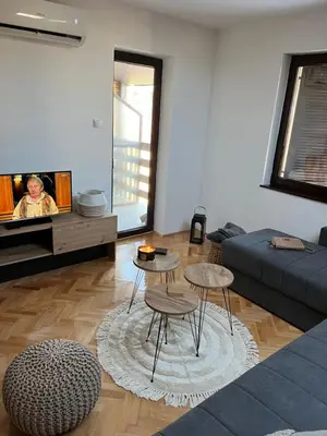 a living room with a couch and a table at Stanoteka in Vrnjačka Banja