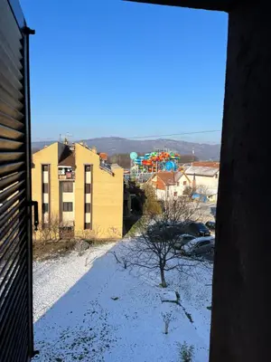 a view from an open door of a city at Stanoteka in Vrnjačka Banja