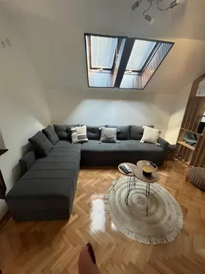a living room with a couch and a table at Stanoteka in Vrnjačka Banja