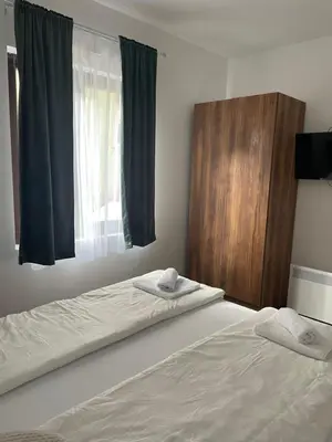 a bedroom with a bed with two towels on it at Vila Bosa - Stara planina in Crni Vrh