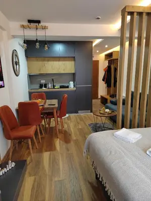 a kitchen and dining room with a table and chairs at President Kop Paxson in Kopaonik