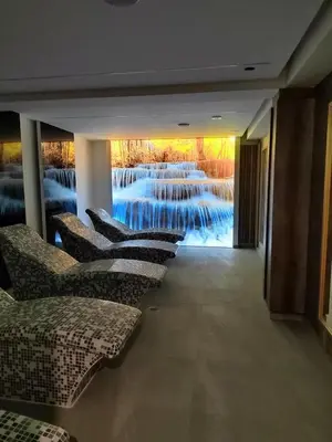 a row of chairs in a room with a painting on the wall at President Kop Paxson in Kopaonik