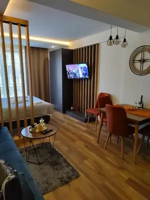 a living room with a couch and a dining room at President Kop Paxson in Kopaonik
