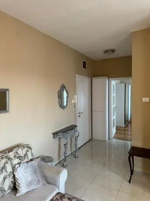 a living room with a couch and a table at Trident Apartments 3 in Niš