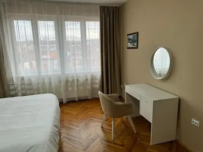 a bedroom with a desk and a bed and a mirror at Trident Apartments 3 in Niš