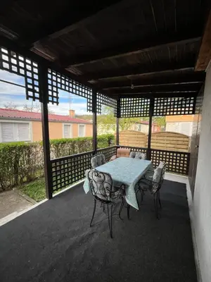 a patio with a table and chairs on a deck at Villa Lenka Sokobanja in Soko Banja