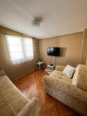 a living room with a couch and a flat screen tv at Villa Lenka Sokobanja in Soko Banja