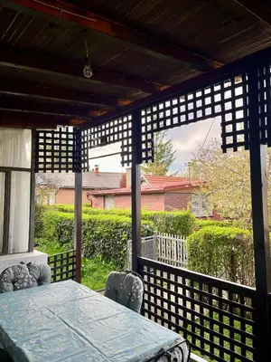 a wooden pergola with a table and chairs on a patio at Villa Lenka Sokobanja in Soko Banja