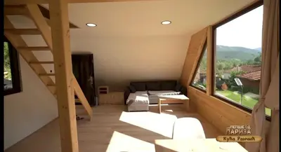 a living room with a couch and a large window at Kuca Rancic in Pirot