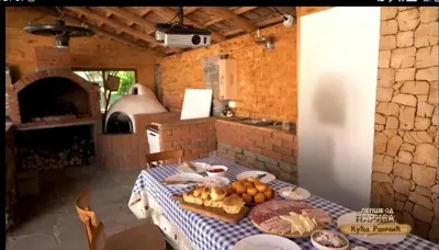 a table with a blue and white checkered table cloth at Kuca Rancic in Pirot