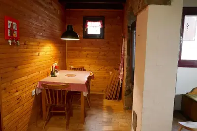 a dining room with a table in a wooden room at Planinska kuća Savić, Kopaonik in Kopaonik