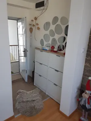 a kitchen with a white cabinet and a mirror at Apartman VUK in Pirot