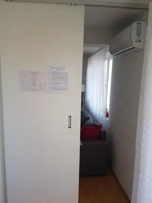 a living room with a couch and a window at Apartman VUK in Pirot