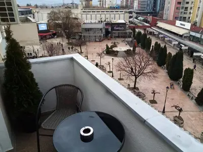 a cup of coffee sitting on a table on a balcony at Apartman VUK in Pirot