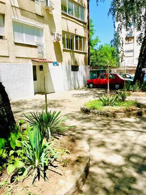 a red car parked in front of a building at Happy Sweet Apartment in Niš