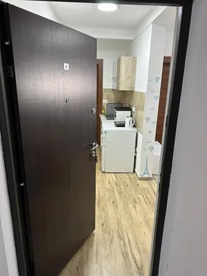 a door leading into a kitchen with a refrigerator at Apartmani Liman Kopaonik in Kopaonik