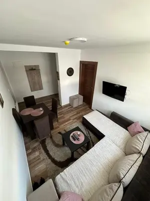 a living room with a couch and a table at Apartmani Liman Kopaonik in Kopaonik