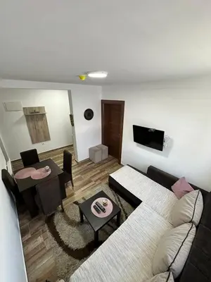 a living room with a couch and a table at Apartmani Liman Kopaonik in Kopaonik