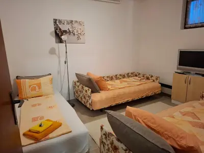a living room with two couches and a couch at Nela Apartmani in Niš