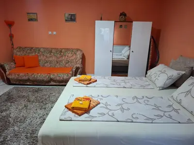a living room with two beds and a couch at Nela Apartmani in Niš