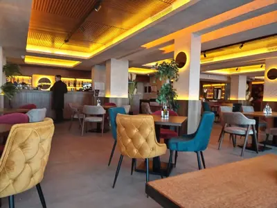 a restaurant with chairs and tables and a bar at N Lux 95 Milmari in Kopaonik