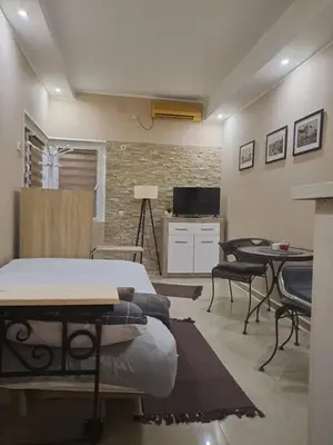 a room with a bed and a table and chairs at Golden Star Viktor in Zaječar