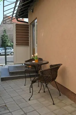 a patio with a table and chairs on a patio at Golden Star Viktor in Zaječar