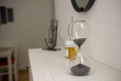 an hourglass sitting on top of a table at Apartment Infinity in Kruševac