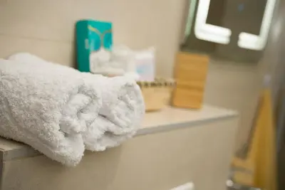 a white towel sitting on a counter in a bathroom at Apartment Infinity in Kruševac