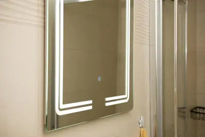 a mirror on the wall of a bathroom at Apartment Infinity in Kruševac