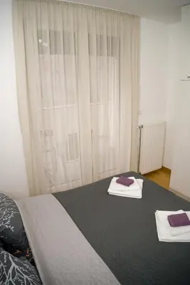 a bedroom with a bed with two towels on it at Apartment Infinity in Kruševac