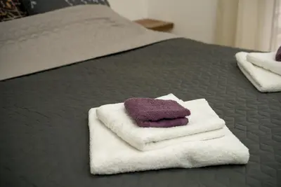 a couple of towels sitting on top of a bed at Apartment Infinity in Kruševac